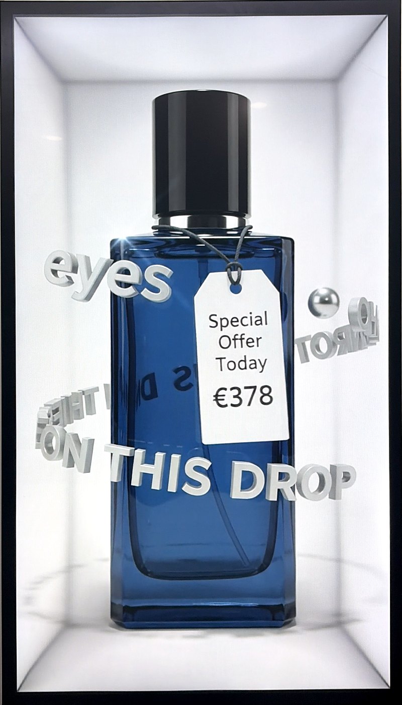 Blue cologne bottle with floating type inside a Translook spatial display